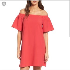 Red off the shoulder dress.